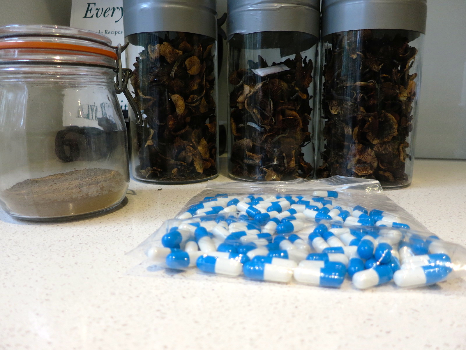 magic mushrooms in glass jars, powdered mushrooms and caps 